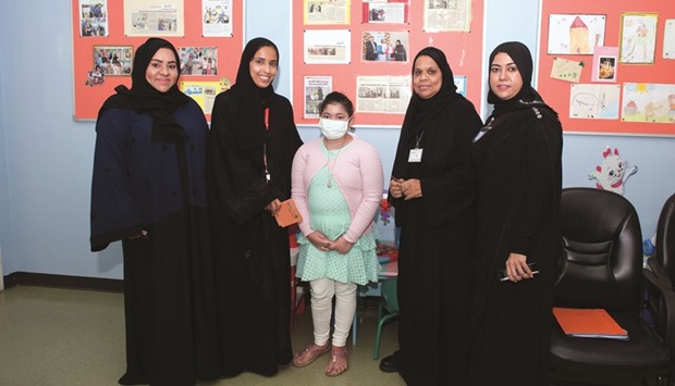 Fatima Sultan al-Kuwari, director, Community and Public Relations at Ooredoo, with one of the young patients at Hamad Hospital.
