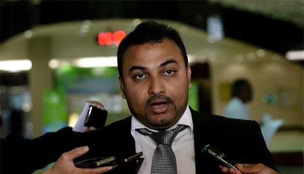 Malaysian lawyer Balan Nair, representing families of flight MH17 crew members, speaks with journalists prior to filing the lawsuit at the Kuala Lumpur Courts Complex on Thursday.
