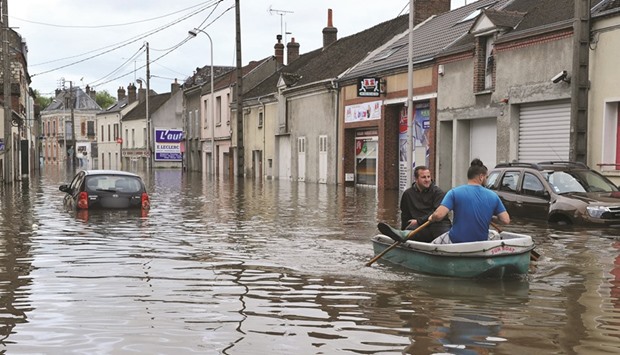 Residents use a boat on a flooded street of Montargis, south of Paris.