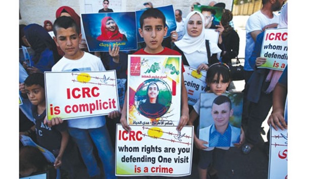 Families of Palestinians who are imprisoned in Israeli jails protest in front of the International Red Cross offices in Jerusalem on Tuesday.