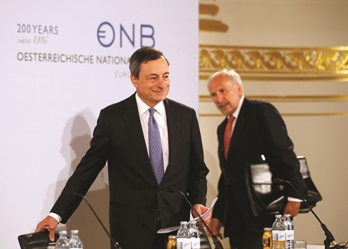 ECB president Mario Draghi and president of the Austrian National Bank and European Central Bank Governing Council member Ewald Nowotny (right) arrive for a news conference in Hofburg palace in Vienna yesterday. u201cEuropeu2019s economic recovery continues to be dampened by subdued prospects in emerging markets, the balance-sheet adjustments in a number of sectors, and sluggish implementation of structural reforms,u201d Draghi said.