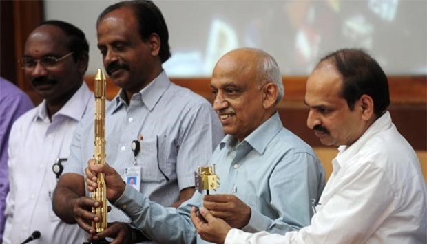 Indian Space Research Organisation chairman Kiran Kumar Rao (second right), along with members of the team, gestures as he displays models of the ISRO's Cartosat-2 and the Polar Satellite Launch Vehicle (PSLV-C34) during a media briefing at the Satish Dhawan Space Centre at Sriharikota in Andhra Pradesh on Wednesday.