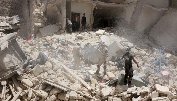 Syrian rescuers search the rubble of a destroyed buildings