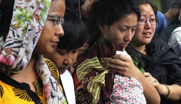Nepalese relatives of 12 victims of a suicide bomb attack react as they pay their last respects alongside the coffins of those killed in Kathmandu on June 22, 2016.