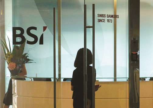 An employee enters the reception area of Swiss bank BSIu2019s office in Singapore. The Monetary Authority of Singaporeu2019s clampdown on BSI over its ties to a Malaysian state investment fund, its most stringent action in three decades, underscores how regulators are increasingly determined to root out money laundering.