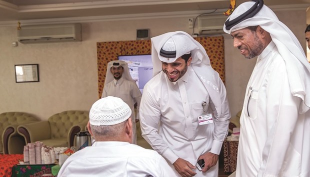 AZF delegates interacting with an elderly person.