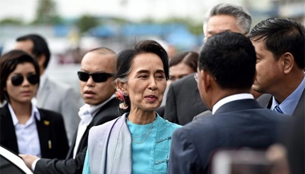 Myanmar's foreign minister and state counsellor Aung San Suu Kyi smiles upon her arrival at a market in Samut Sakhon province, west of Bangkok, on Thursday.