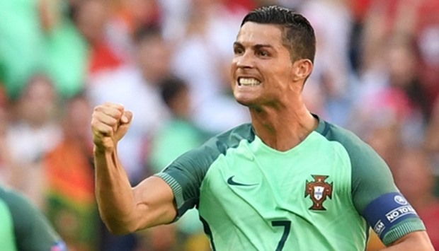 Portugal's forward Cristiano Ronaldo (R) celebrates after scoring a goal