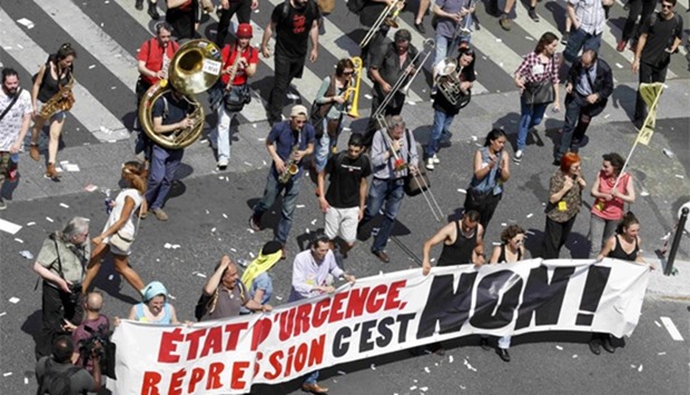 Striking employees attend a demonstration against plans to reform French labour laws in Paris