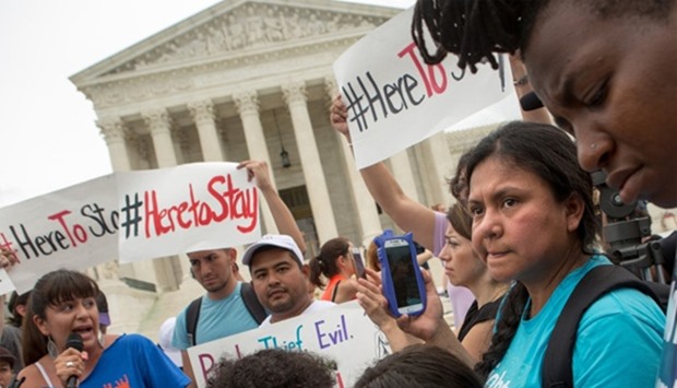 Families react to news on a Supreme Court decision blocking Obama's immigration plan