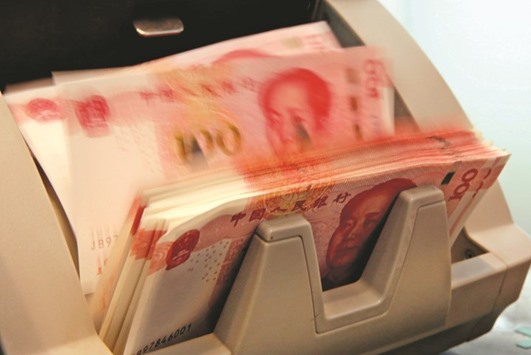 Chinese 100 yuan banknotes are seen in a counting machine at a bank branch in Beijing. Chinau2019s total debt hit 168.48tn yuan at the end of last year, equivalent to 249% of the national GDP, according to top government think tank the China Academy of Social Sciences.