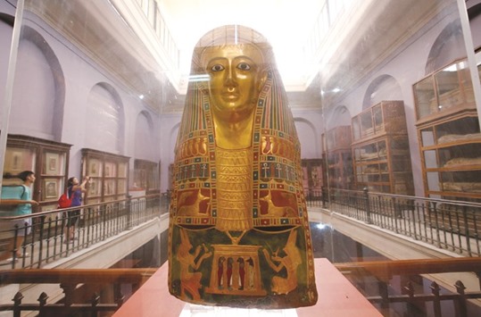 Tourists walk around pharaonic artefacts inside the Egyptian Museum in Cairo.