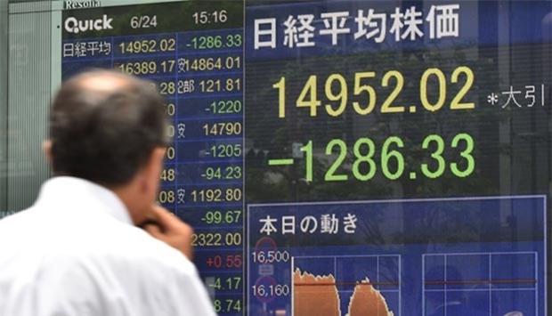 An electronic stock indicator is pictured in Tokyo on Friday. Tokyo stocks went into a hair-raising dive on Brexit fears.