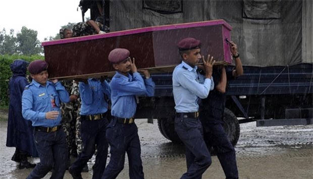 Nepalese soldiers carry the coffin of one of the 14 Nepalese victims killed in a suicide bomb attack in Kabul, in Kathmandu on Thursday.