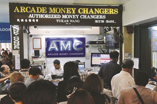 A vendor counts the British pound at a money changer booth in Singapore yesterday. The pound nosedived against the US dollar and other currencies.