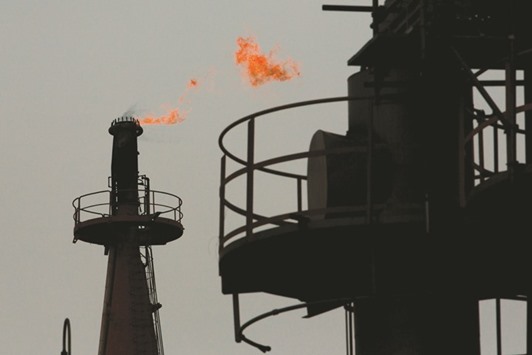 Flames shoot out of a chimney at a petrochemical plant in Kawasaki near Tokyo. Big firms in Japan plan to increase their capital spending by 5.9% for this fiscal year, up from plans to cut capex by 0.9%, the BoJu2019s quarterly tankan business sentiment survey showed.