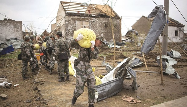 Soldiers work in the rubble of destroyed houses after a tornado in Funing, in Yancheng, in Chinau2019s Jiangsu province yesterday.