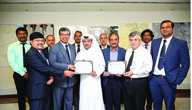 Khaled Saif al-Khayarein with representatives of the project contractor, a Larsen and Toubro and Galfar Al Misnad joint venture, at the ceremony.