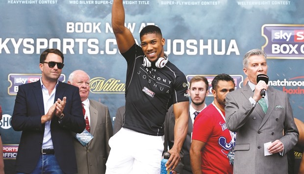 Anthony Joshua steps up for weigh-in on the eve of his bout against Dominic Breazeale in London yesterday. (Reuters)