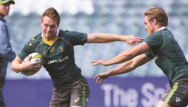 Australian rugby player Dane Haylett-Petty (left) fends off a tackle from teammate Michael Hooper during the teamu2019s captainu2019s run in Sydney yesterday. (AFP)