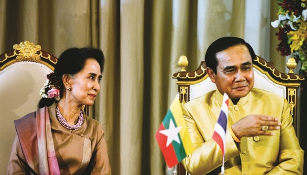 Myanmar Foreign Minister and State Counsellor Aung San Suu Kyi and Thai Prime Minister Prayut Chan-O-Cha attend an MoU ceremony at the government house in Bangkok, yesterday.