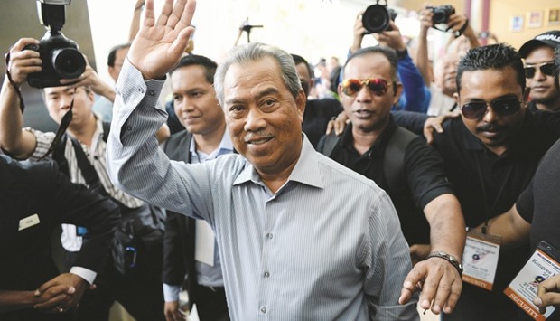 File photo shows Malaysiau2019s former deputy Prime Minister Muhyiddin Yassin (centre) waving as he arrives during a rally in Shah Alam, outside Kuala Lumpur.