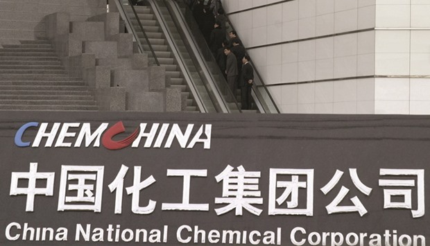 People use an escalator outside the headquarters of ChemChina in Beijing. The Chinese firm and Russiau2019s biggest oil producer Rosneft signed a new one-year oil supply contract, sources said yesterday.