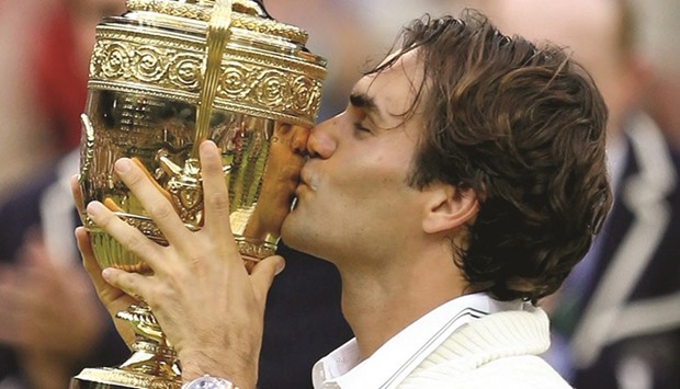 Roger Federer with the 2012 Wimbledon trophy.