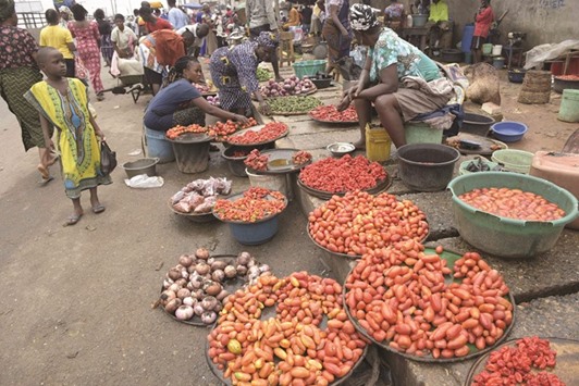 Vendors displaying tomatoes and pepper at Mile 12 market in Lagos.