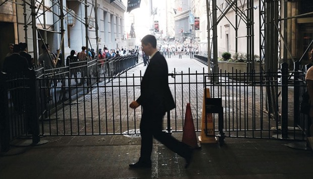 A trader walking out of the New York Stock Exchange (NYSE) on Wall Street following news that the United Kingdom has voted to leave the European Union on Friday. The Dow Jones industrial average closed down over 600 points on the news with markets around the globe plunging.