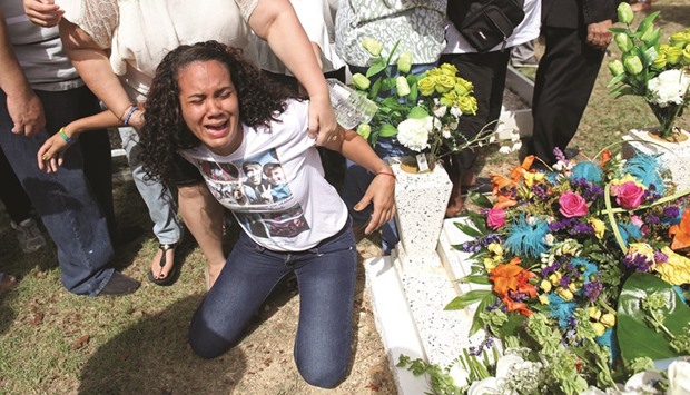 A relative of Xavier Emmanuel Serrano Rosado, one of the victims of the shooting at the Pulse night club in Orlando, reacts during his funeral in his hometown of Ponce, Puerto Rico, on Friday.
