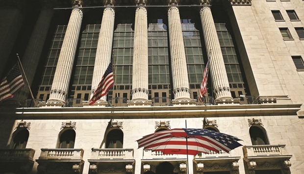 People walk by the New York Stock Exchange. The worldu2019s financial markets passed a key test on Friday, operating without a hitch across asset classes amid a surge in trading volume and price swings triggered by Britainu2019s vote to leave the European Union.