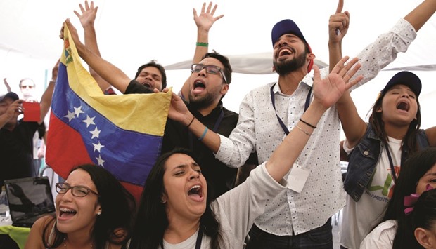 People react at the end of Venezuelau2019s National Electoral Council (CNE) second phase of verifying signatures for a recall referendum against President Nicolas Maduro outside a validation centre in Caracas.