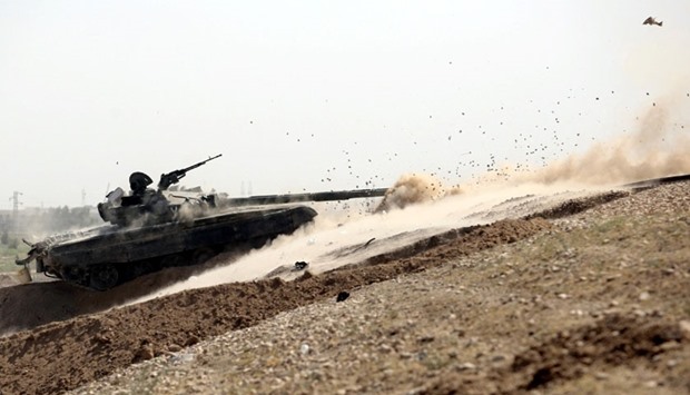 A tank belonging to the Iraqi army fires toward Islamic State militants in Fallujah, Iraq.