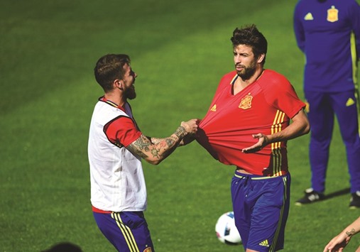 Sergio Ramos (left) and Gerard Pique joke during Spain teamu2019s training session yesterday. (AFP)