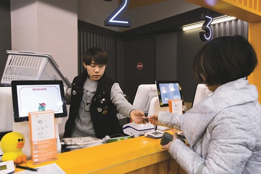 A customer pays with a credit card at the Line Friends flagship store, operated by Line Corp in Seoul. Lineu2019s initial public offering in the next three weeks is set to raise about $1bn, which given a global drought of such deals could make it the biggest tech listing this year.