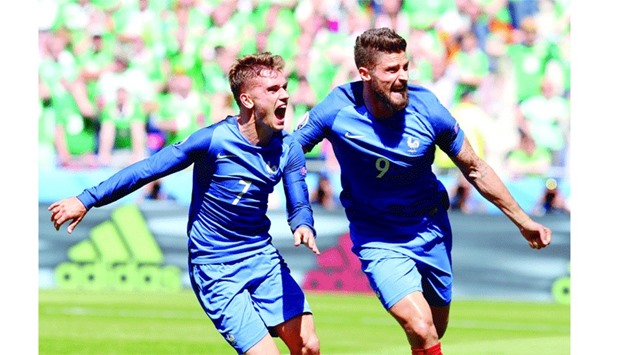 Antoine Griezmann (left) celebrates with strike partner Olivier Giroud after scoring his second goal against Ireland in their Euro Round of 16 match in Lyon yesterday. (AFP)