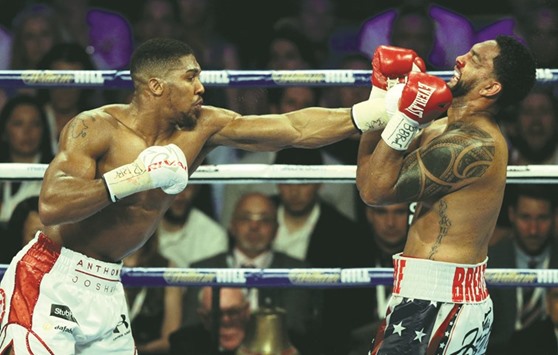 Anthony Joshua (left) lands a punch on Dominic Breazeale during the IBF World Heavyweight Title bout at The O2 Arena in London on Saturday. (Reuters)