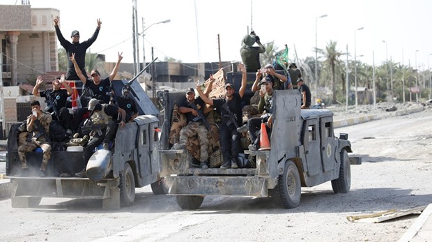 Iraqi counterterrorism forces gesture in Fallujah yesterday.