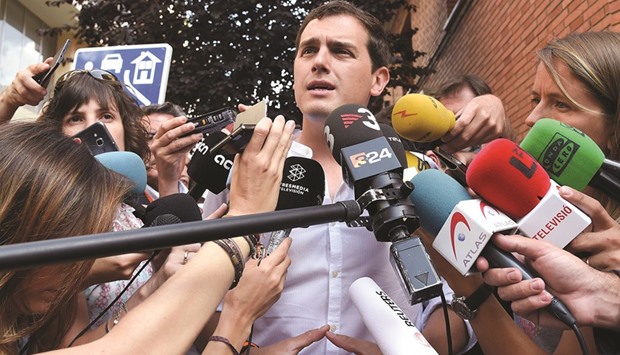 Center-right party Ciudadanos leader Albert Rivera speaks to journalists after casting his vote in Hospitalet, near Barcelona.