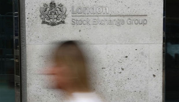 Pedestrians pass the entrance to the London Stock Exchange in central London on June 27, 2016. Shares in banks, airlines and property companies plunged on the London stock exchange Monday as investors singled out the three sectors as being the most vulnerable to Britain's decision to leave the EU.