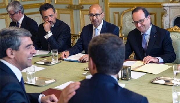 French President Francois Hollande (R), flanked by French Minister of State for European Affairs Harlem Desir (2nd R), meets his Bulgarian counterpart Rosen Plevneliev (2nd L)