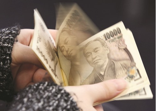 A woman counts yen notes in Tokyo. The yen rally will reduce Japanu2019s import costs and render its exports less competitive, making the central banku2019s 2% inflation target a more distant prospect.