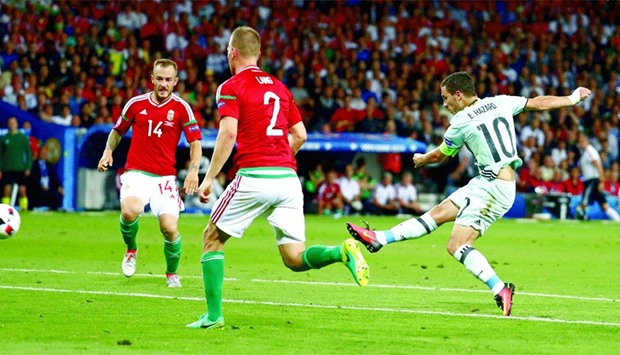 Belgiumu2019s Eden Hazard (right) shoots to score his teamu2019s third goal against Hungary during their Euro 2016 Round of 16 match in Toulouse on Sunday. Belgium won 4-0. (Reuters)