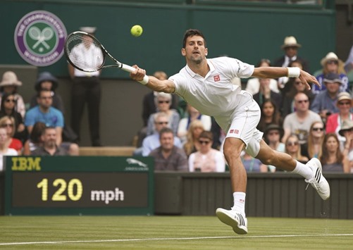 Serbiau2019s Novak Djokovic hits a return during his win over Great Britainu2019s James Ward at Wimbledon yesterday. (Reuters)