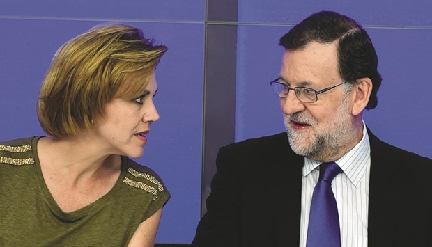 Popular Party (PP) leader and Spainu2019s caretaker Prime Minister Mariano Rajoy speaks with party general secretary Maria Dolores de Cospedal during a meeting of the national executive committee in Madrid yesterday.