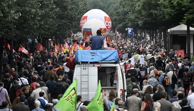 People hold flags during a demonstration against controversial labour reforms