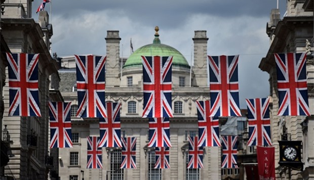 Union flags fly as banners across a street in central London