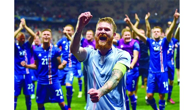 Icelandu2019s captain Aron Gunnarsson and teammates celebrate their historic win over England at the Euro 2016 in Nice on Monday. (AFP)