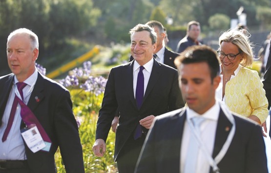 ECB president Mario Draghi (centre) arrives at the ECB Forum in Sintra, Portugal, yesterday. Acknowledging that ultra-loose monetary policies have u201cinevitablyu201d created potentially destabilising spillover effects, Draghi said there is a u201ccommon responsibilityu201d to address the worldu2019s economic weaknesses.